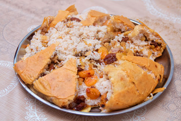 Shah Pilaf with fire on a table in restaurant . Shah pilaf. Khan pilaf in a pita. Pilaff . Pilau . Pilaw . Traditional oriental dish . on tableware . Azerbaijan , Baku .