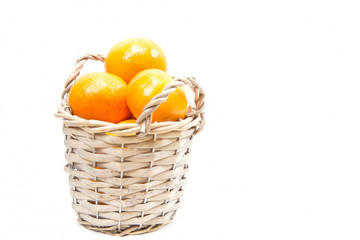Fresh oranges in basket on white background, isolated