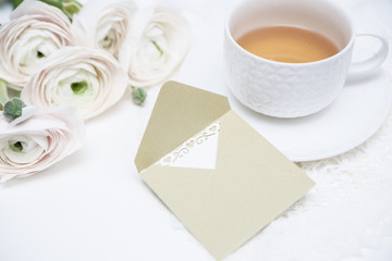 Bouquet of flowers with cup of tea and love letter. Invitation card. Valentines day card.
