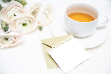 Bouquet of flowers with cup of tea and love letter. Invitation card. Valentines day card.