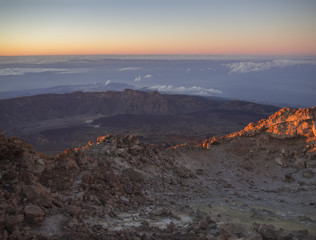 red glow before sunrise with vulcanic landscape from the top of pico del teide vulcano highest spanish mountain on tenerife canary island