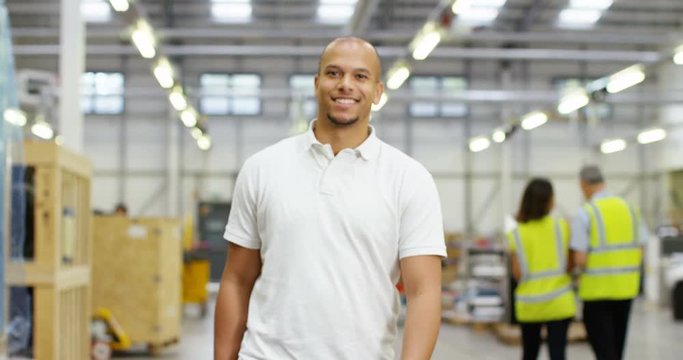 4k, Portrait of a cheerful and friendly African American female warehouse manager. Slow motion.