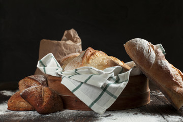 freshly baked bread on a wooden table on a dark background