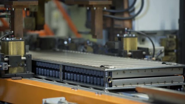 Working Conveyor Belt on the heating radiator Plant with Spot Welding Robots