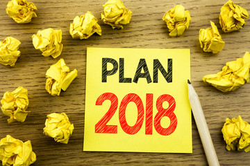 Fototapeta premium Word, writing Plan 2018. Business concept for Planning Strategy Action Plan written on sticky note paper on the wooden background. Folded yellow papers on the background