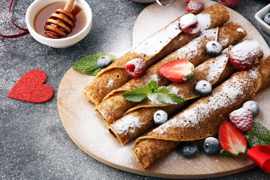 Delicious Tasty Homemade crepes or pancakes with raspberries and blueberries. Valentine concept