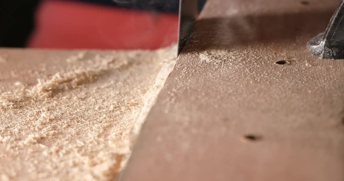 Electric jigsaw cutting the wood