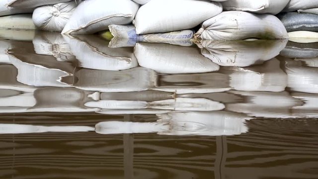 Reflection of a sandbag barrier in flood water