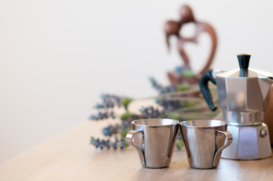 A Tray Of A Form Of A Saddle With Two Cups Of Coffee, A Coffee Maker, Biscuits And Flowers