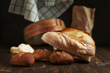 freshly baked bread on a wooden table on a dark background