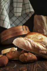 freshly baked bread on a wooden table on a dark background