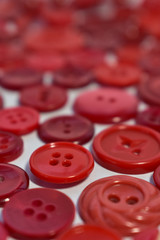 red sewing buttons on white
