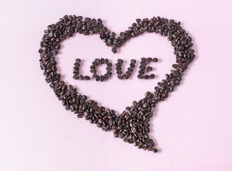 Decorative heart composed of coffee beans with 'LOVE' writing