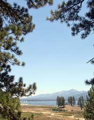 Lake and mountains through trees