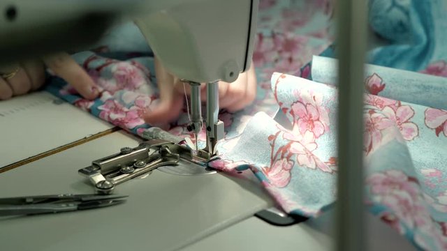 process of quilting on patchwork blanket close up sewing machine hands production