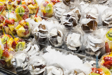 Salad sliced from fresh fruit in a plastic cup
