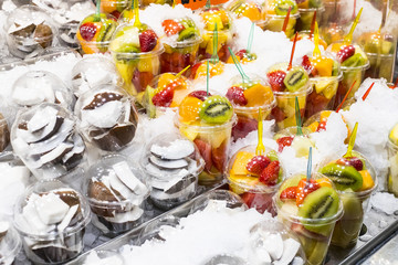 Salad sliced from fresh fruit in a plastic cup