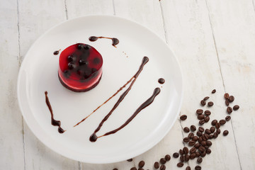 jelly cake with currant on a biscuit on a white plate