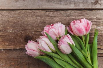 Bouquet of pink tulips over shabby wooden table. Spring greeting card happy mother day copy space