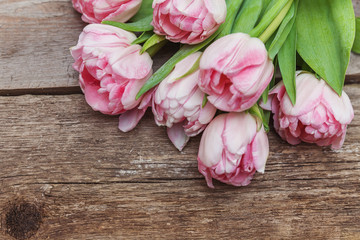 Bouquet of pink tulips over shabby wooden table. Spring greeting card happy mother day copy space