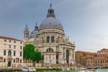 Fototapeta na wymiar VENICE, ITALY - on May 5, 2016. View on Santa Maria della Salute church at sunrise.Tourists from all the world enjoy the historical city of Venezia in Italy, famous UNESCO World Heritage Site