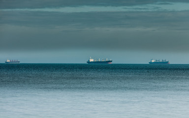 Fototapeta premium cargo conteiner ships sailing in still water