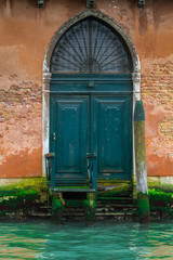 VENICE, ITALY - on May 5, 2016. Enigmatically colorful wooden door on Grand Canal in Venice City of Italy
