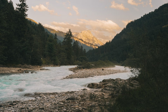 Scenic view of river flowing against cloudy sky in forest