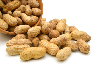 Dried peanuts in wooden bowl on white