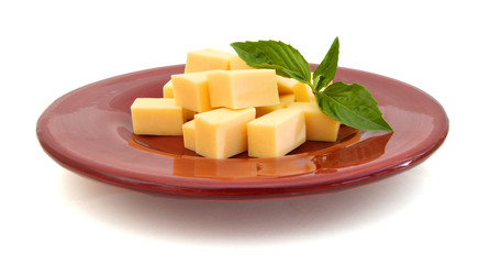 piece of cheese in plate on a white background