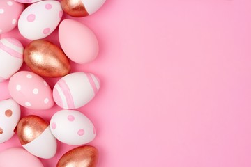 Obraz na płótnie Canvas Easter egg side border. Rose gold, soft pink and white colors on a pink background.