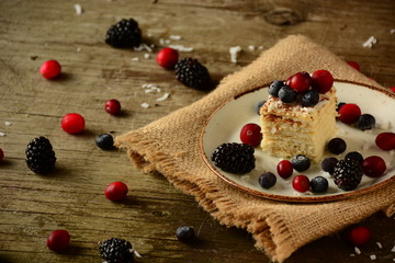 Piece of cake napoleon on a plate with sweet fresh berries