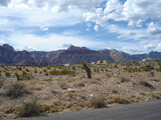 Driving Through Nevada with Mountains and a Blue Sky Background