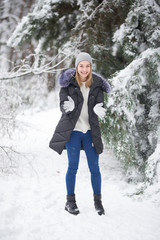 cheerful girl in a winter forest