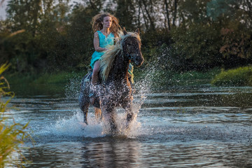 Fototapeta na wymiar Girl riding horse on water surface