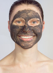 woman gets cosmetic mask on face. beautiful girl in facial mask. portrait.