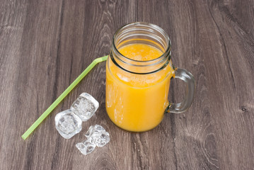 mango smoothies on wooden background