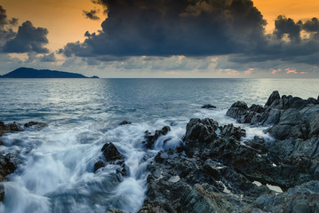 Seascape of wave on rock , Long Exposure at Sunset on the beach in Phuket Thailand.