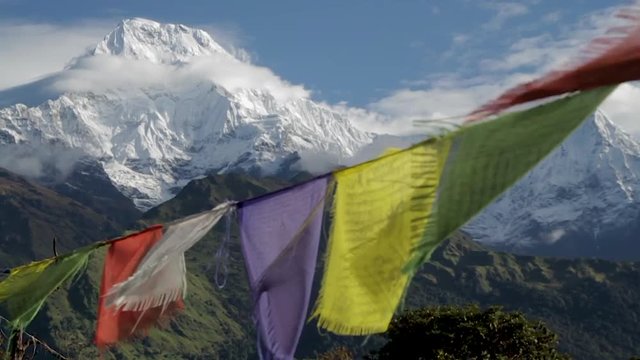 Nepalese Prayer Flags Flapping in Wind in Front of Himalayan Mountains.