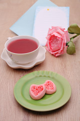 Strew berry heart cookies  on green plate 