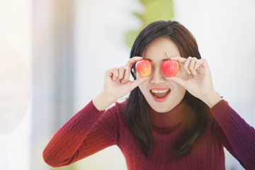 Portrait of young asian cute woman hold red apple .