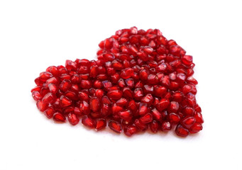 pomegranate in shape of a heart on white background