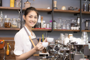Asian Barista woman making Coffee with coffee machine in the coffee shop. people with barista in cafe concept.