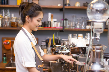 Asian Barista woman making Coffee with coffee machine in the coffee shop. people with barista in cafe concept.