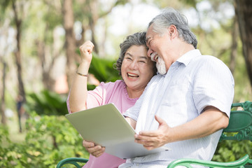 Obraz premium Elder people using laptop with excited emotion together. People lifestyle concept.