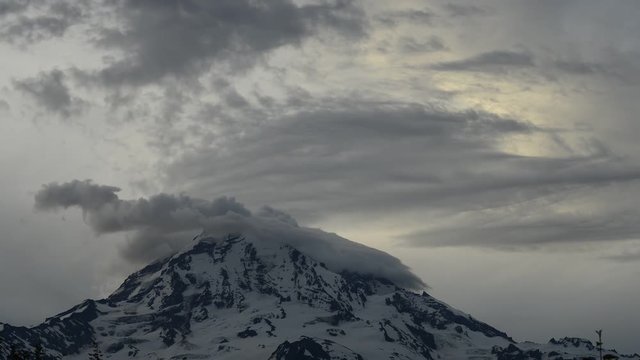 Time lapse lockdown shot of cloudscape over snow covered mountain at Mount Rainier National Park