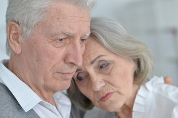 sad senior couple posing 