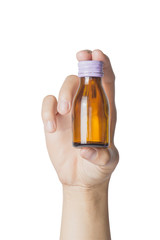 Woman's hand holding empty small brown medicine  bottle liquids transparent on white background. File contains a clipping path.