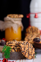 Sweet biscuits with peanuts in a plate with honey and milk on a table