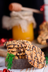 Sweet biscuits with peanuts in a plate with honey and milk on a table